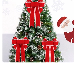 Three red velvet Christmas bows with white plush edges on a festive pine tree