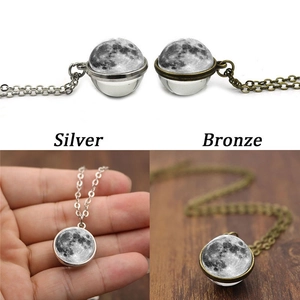 Double-sided glass moon pendant necklace in silver and bronze tones with crescent texture