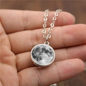 Double-sided glass moon pendant necklace with grey lunar surface and silver chain