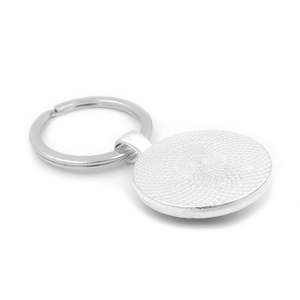 Faith Over Fear metal keychain with silver finish and textured back on white background