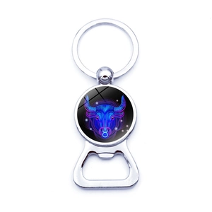 Close-up of Taurus zodiac neon design on silver metal bottle opener keychain