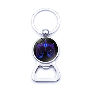 Detail view of Libra zodiac glass cabochon on a chrome-plated metal beer bottle opener keychain