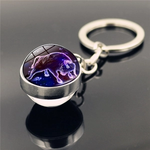 Detailed macro view of Taurus constellation glowing inside a glass ball keychain pendant