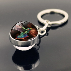 Polished silver hummingbird keychain with vibrant double-sided crystal glass ball pendant