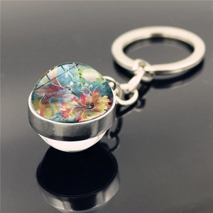Artistic watercolor hummingbird glass cabochon keychain with a polished metal ring