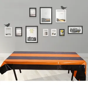 Detail of waterproof black and orange striped tablecloth for Halloween party decor