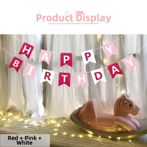 Close-up of red, pink, and white fishtail banners with white Happy Birthday lettering