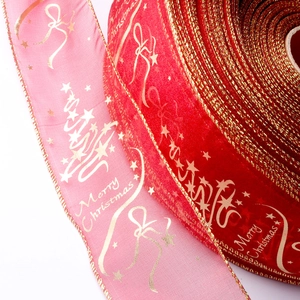 Detail of red and pink Merry Christmas ribbons with gold foil trees and wire edges