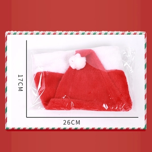 Detail view of plush Christmas hat showing folded size 26x17cm in transparent packaging
