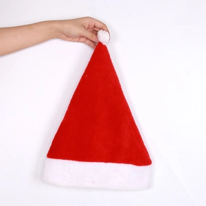 Detail showing soft red short plush texture and white pom-pom on the Christmas hat