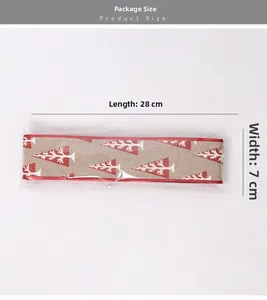 Macro detail of Christmas ribbon with red glitter trees and product dimension labels