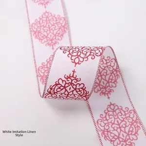 Detail of white faux linen Christmas ribbon with red vine patterns and stitched edges