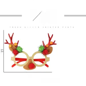 Detail view of glitter Christmas reindeer glasses with red antlers and pom-pom nose