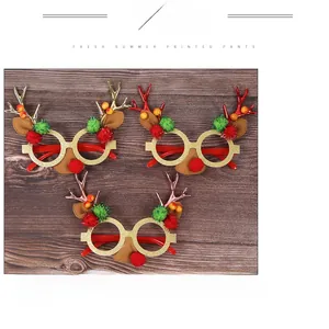 Detailed close-up of three festive Christmas antler glasses with glitter and pompoms