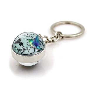 Silver hummingbird keychain with colorful crystal glass ball art pendant on white background