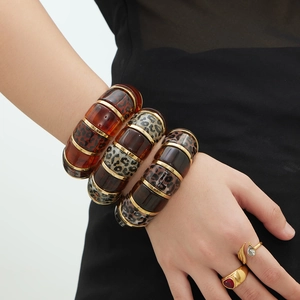 Set of leopard print resin bangles and gold rings for beach and bohemian fashion style