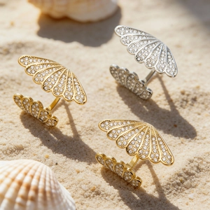 Shell shaped stainless steel rings with 5A zircon in gold and silver on beach sand