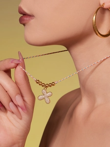 Detailed close-up of a colorful woven cord necklace with a sparkling clover pendant