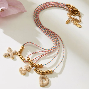 Colorful woven cord necklace with zircon paved alphabet pendants in gold finish