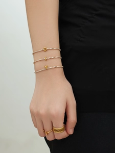 Detail of 18k gold plated tennis bracelets with sparkling zircon initial charms D I V