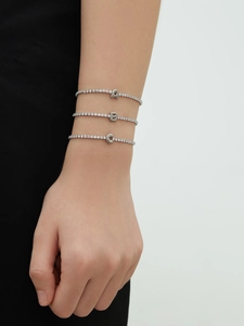 Detailed view of silver-tone bracelets with A, B, and C pavé-set zirconia initial charms