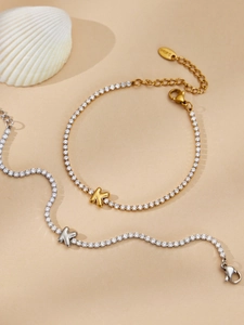 Macro detail of initial K tennis bracelet in gold and silver steel with white zircons