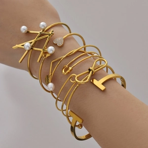 Set of 18k gold plated stainless steel bangles with heart, pearl, and butterfly charms