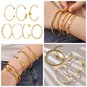 Detail view of 7-piece gold-plated stainless steel hollow heart and pearl bracelet set