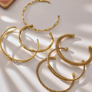 Golden stainless steel bamboo and twisted bracelets set with elegant shadow lighting