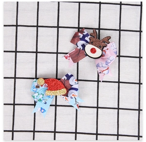 Detailed view of Christmas hair clips with glitter reindeer and festive bow designs