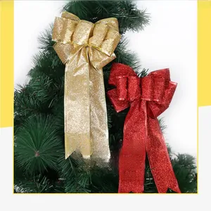 Nahaufnahme von funkelnden roten und goldenen Glitzerschleifen an einem Weihnachtsbaum