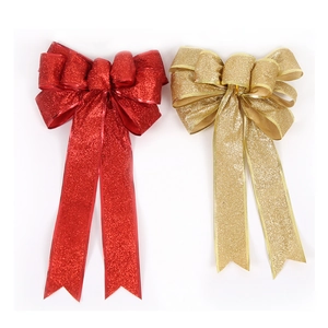Detailansicht roter und goldener Glitzer-Weihnachtsschleifen mit Goldrand für Deko