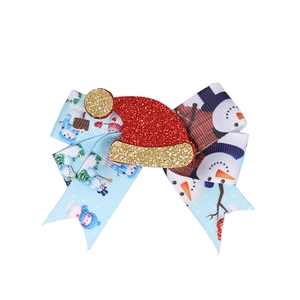Christmas bow hair clip featuring snowman patterns and a glitter Santa hat ornament