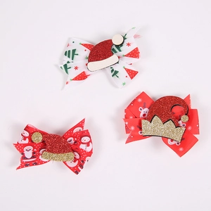 Detailed view of Christmas bow hair clips featuring Santa Claus and reindeer patterns