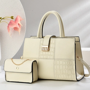 Detail of beige composite bag set showing stone pattern panel and gold metal chain strap
