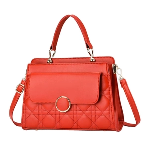 Elegant red quilted leather handbag with gold ring hardware and detachable shoulder strap