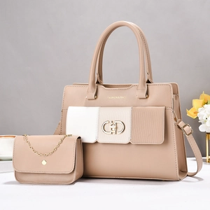 Detail view of multi-layer contrast color tote and crossbody bag set in beige and cream