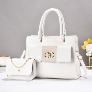Detail view of white leather tote and small chain bag set with gold hardware and text