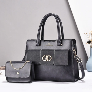 Detail of black matte composite leather tote set with golden GD hardware and chain strap