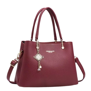 Fashionable burgundy lychee pattern handbag with pearl pendant and adjustable shoulder strap