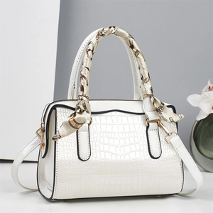 Elegant white crocodile pattern tote bag with decorative scarf and golden hardware