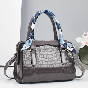 Grey patent leather handbag with crocodile pattern, top handles and decorative scarf