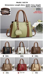 Detail view of large capacity tote bag with contrast colors and mini charm attachment