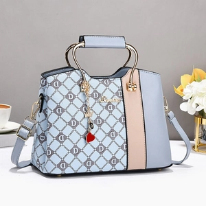Chic blue and beige color-block monogram handbag with U-shaped metal handle and charms