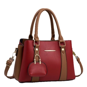 Chic burgundy and brown patchwork leather tote bag with elegant gold metal bar detail