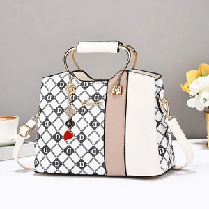 Chic black and white diamond pattern handbag with gold metal handle and red heart charm