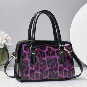 Detailed view of leopard print handbag with purple pattern and glossy black trim