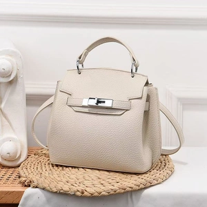 Elegante borsa a mano in pelle crema con chiusura a scatto argento e manico superiore
