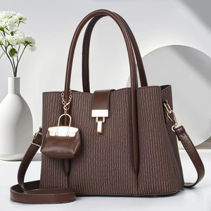 Brown striped tote bag with pleated texture and adjustable shoulder strap in minimalist setting