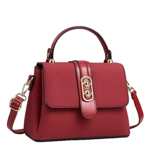 Fashionable dark red canvas textured handbag with leather strap and gold metal buckle